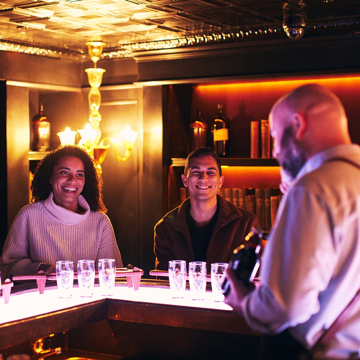 Two friends sit at the private Connoisseur bar at the Guinness Storehouse